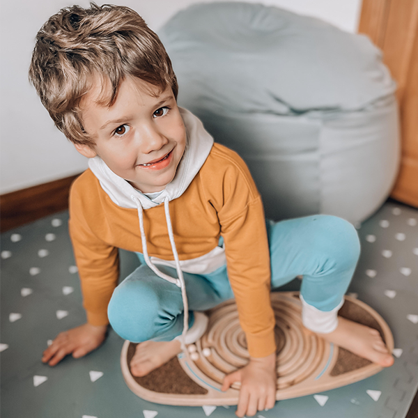 Child playing on a wobble board