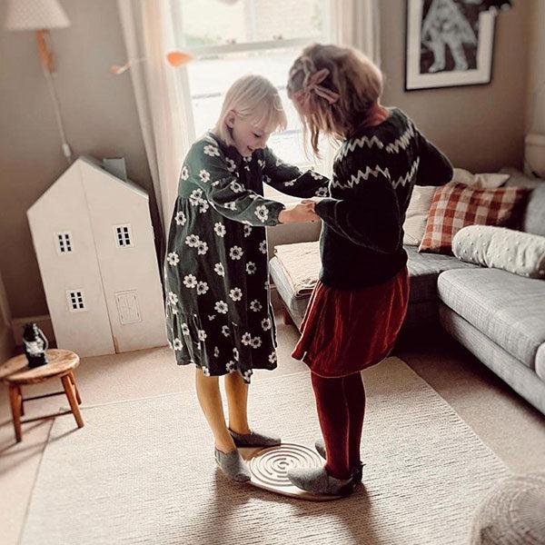 Girls playing on a wobble board