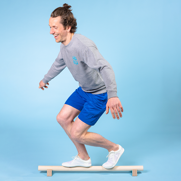 man standing on a balance beam